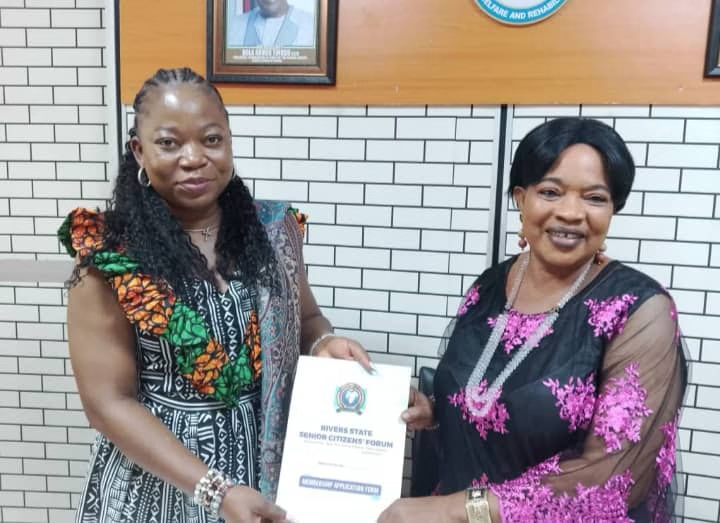 The Permanent Secretary, Ministry of Social Welfare and Rehabilitation, Lauretta Davies-Dimpka (left), and the Rivers State President, Senior Citizens Forum, Barr. Georgiana Tenelo presenting their membership form to the former.